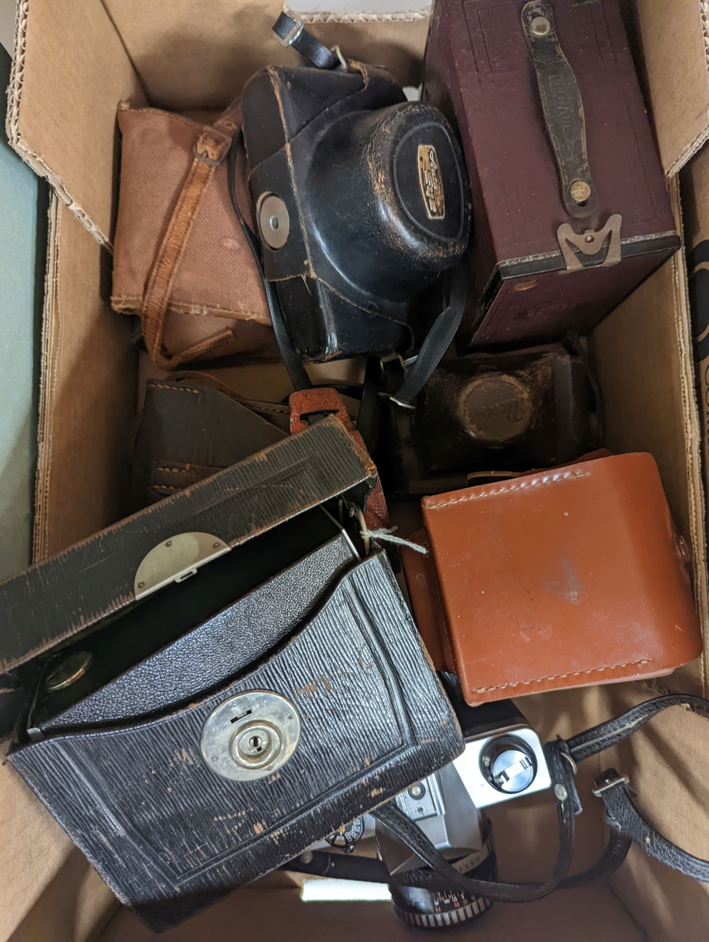 A Polyscop stereo camera together with other 20th century cameras
